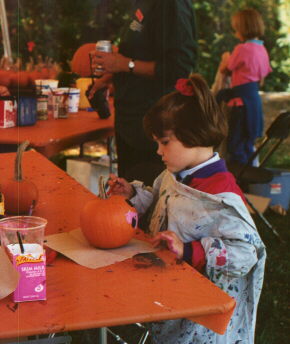 Young girl designing a jack-o-lantern