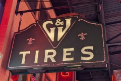 GJ Tires sign with cast milkglass letters